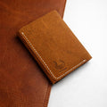 The Drifter trifold wallet in distressed tan Crazy Horse leather with contrast white stitching and the BoldHorn emboss