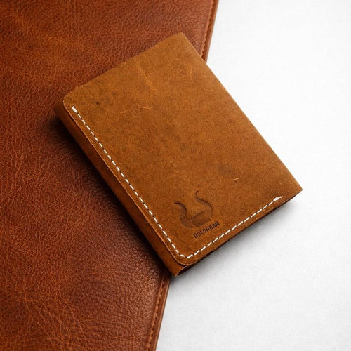 The Drifter trifold wallet in distressed tan Crazy Horse leather with contrast white stitching and the BoldHorn emboss