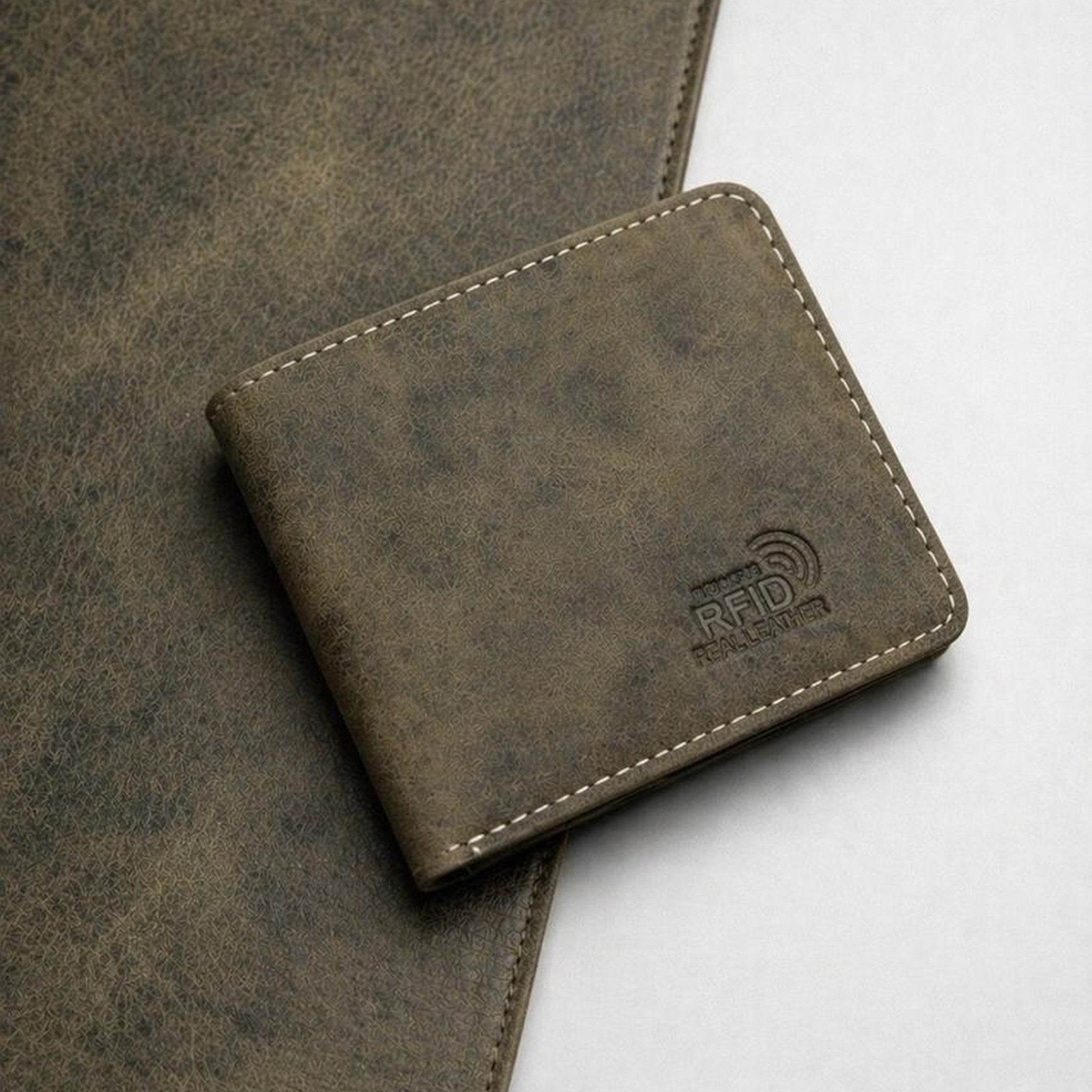 The Ranger bifold wallet in distressed olive Crazy Horse leather with cream stitching and an RFID stamp