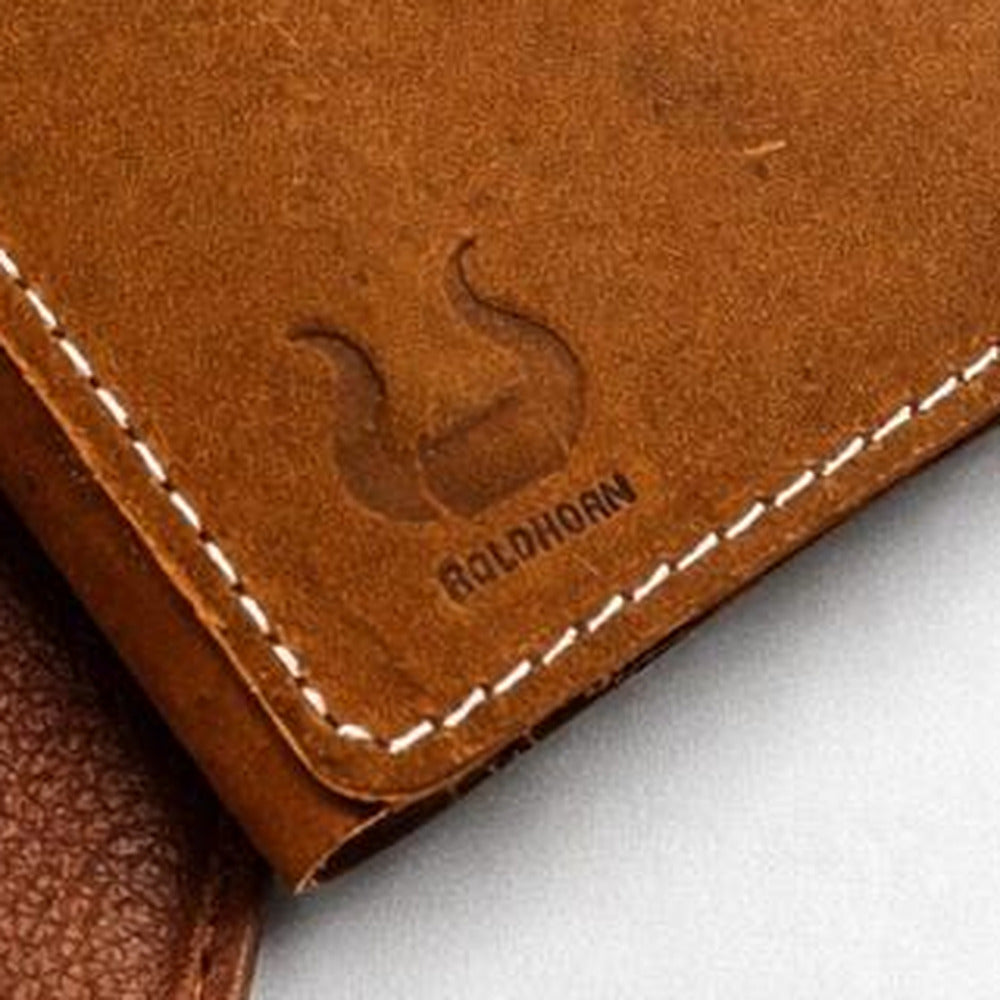 The BoldHorn horn mark blind-embossed into the front panel beside hand-stitched white thread