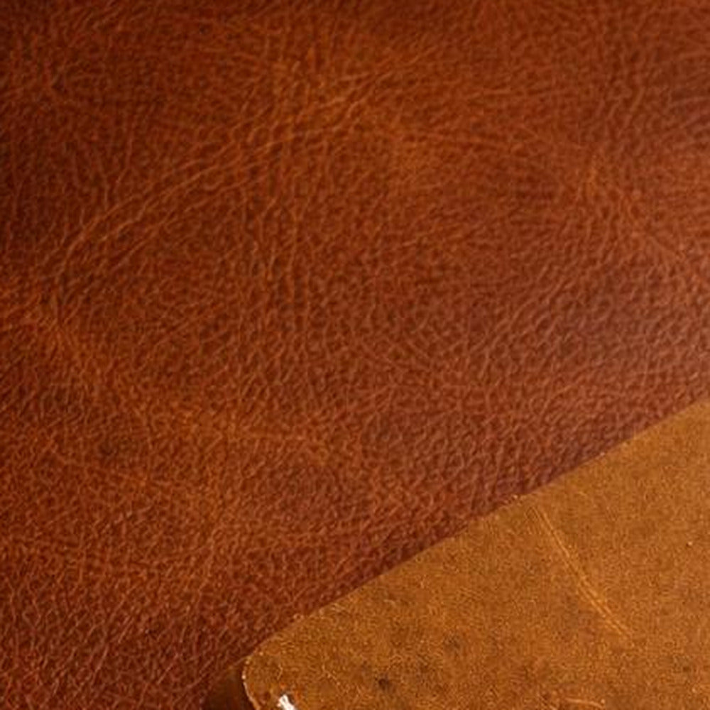 Close detail of full-grain Crazy Horse hide showing natural pebbling and colour variation